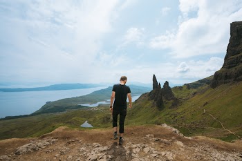 Man Wearing Black T-shirt Standing On Cliff