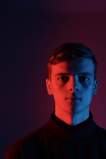Man Wearing Black Top Standing on Dimmed Room