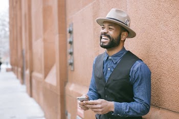 Man Wearing Black Vest and Blue Denim Shirt
