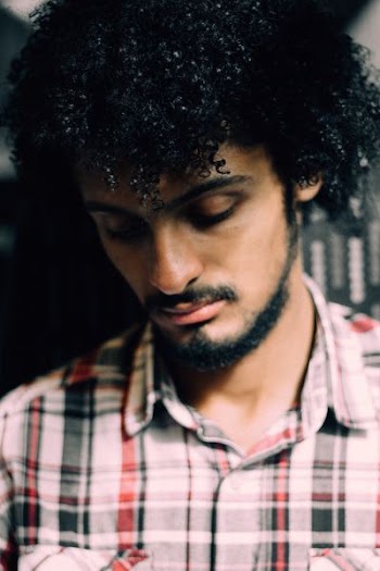 man wearing black, white, and red plaid top