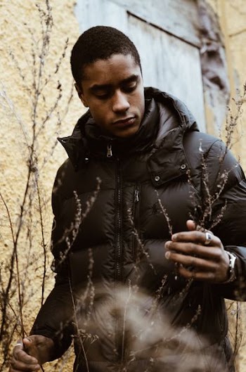 man wearing black zip-up bubble jacket