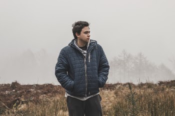 Man Wearing Black Zip-up Hooded Jacket Standing
