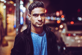 Man Wearing Black Zip-up Jacket And Blue Top 