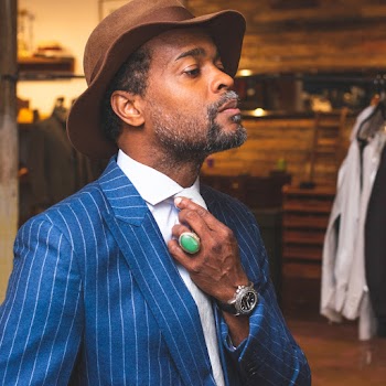 Man Wearing Blue and Gray Pinstriped Suit Jacket