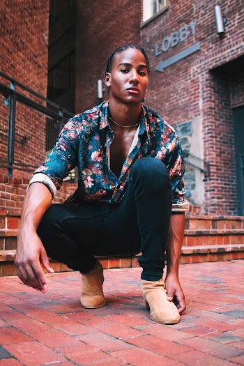 Man Wearing Blue and Pink Floral Shirt and Black Pants