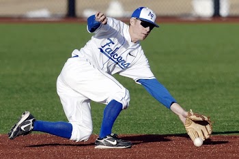 Man Wearing Blue and White Falcons Baseball Jersey Shirt With Brown Baseball Gloves Catching White Baseball