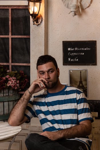 Man Wearing Blue And White Striped Crew-neck T-shirt Sitting