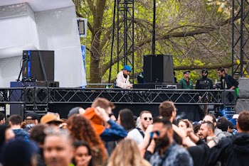 Man Wearing Blue Cap Performing on Stage