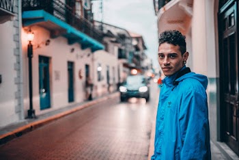 Man Wearing Blue Coat Standing on Street