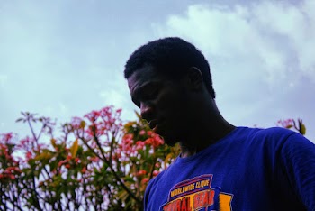 Man Wearing Blue Crew Neck Shirt Looking Down