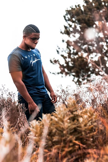 Man Wearing Blue Crew-neck T-shirt Standing Near the Tree Outdoor