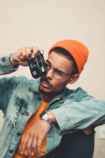 Man Wearing Blue Denim Button-up Jacket Holding Black Camera