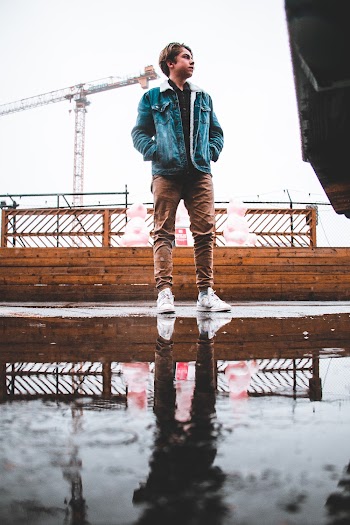 Man Wearing Blue Denim Jacket and Brown Pants