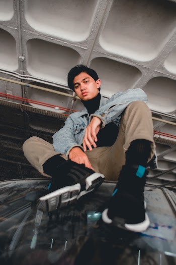 Man Wearing Blue Denim Jacket and Brown Pants