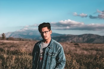 Man Wearing Blue Denim Jacket and Eyeglases