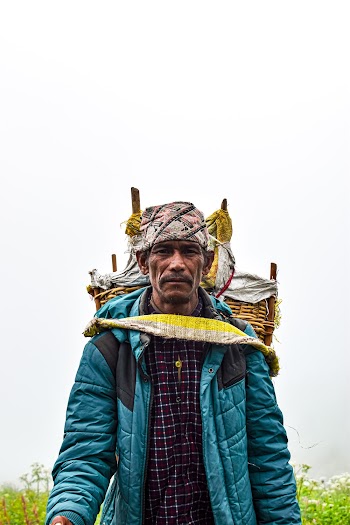 Man Wearing Blue Jacket With Brown Basket on His Back While Standing