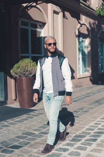 Man Wearing Blue Jeans Walking Beside Brown Vase