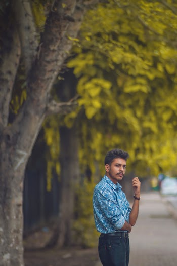Man Wearing Blue Long-sleeved Shirt Standing Beside Trees