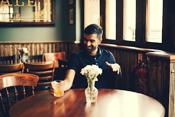 Man Wearing Blue Polo Shirt Holding Clear Rocks Glass