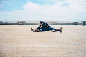 man wearing blue sweater and gray pants
