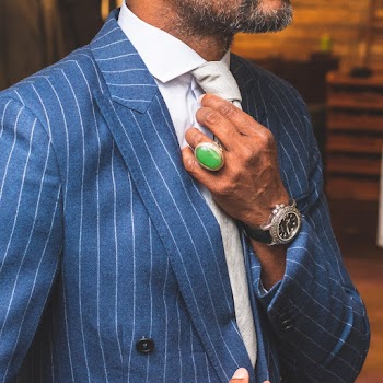 Man Wearing Blue Tuxedo Holding Tie