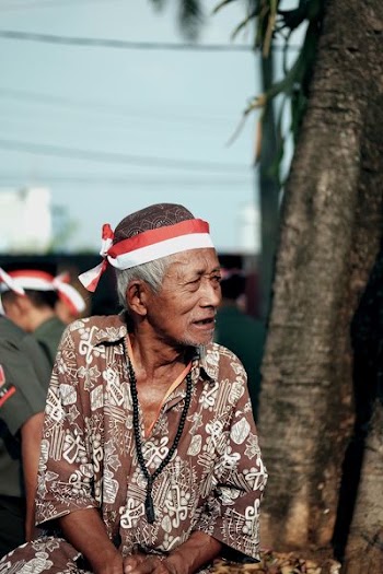man wearing brown and white top