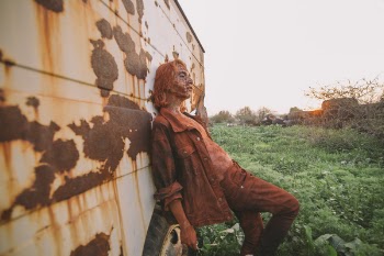Man Wearing Brown Button-up Jacket and Pants Leaning on Wall