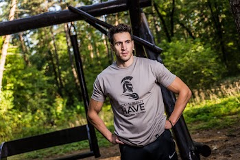 Man Wearing Brown Crew-neck T-shirt Standing Near Brown Wooden Swing at Daytime