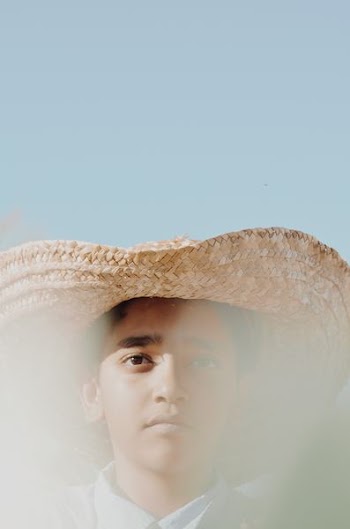man wearing brown hat