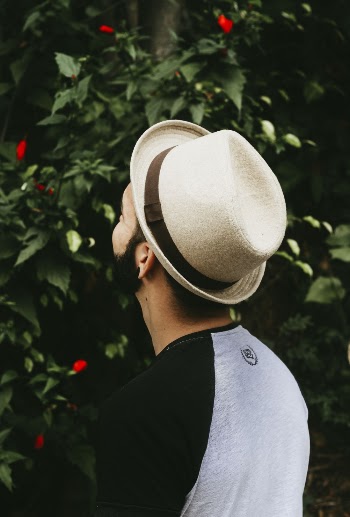 Man Wearing Brown Hat Looking on Green Leaf Plant