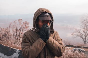 Man Wearing Brown Jacket and Black Gloves