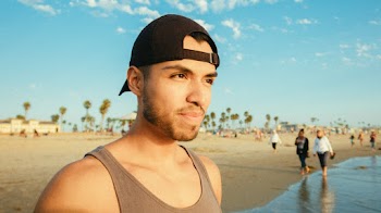 Man Wearing Brown Tank Top and Black Cap
