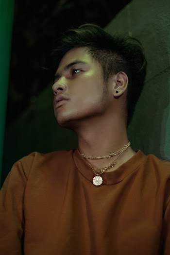 Man Wearing Brown Top and Necklace