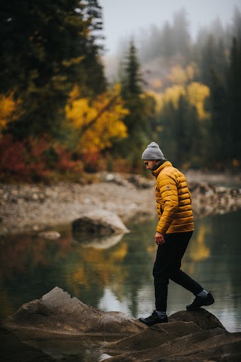 Man Wearing Bubble Jacket Standing Near Lake