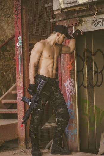 Man Wearing Camouflage Pants Holding Toy Gun
