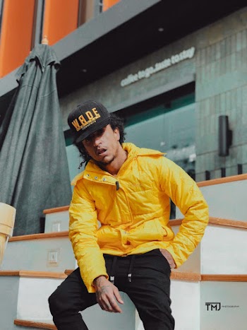 Man Wearing Cap and Yellow Jacket Taking Selfie