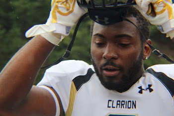 Man Wearing Clarion Under Armour Football Jersey Takes on Helmet
