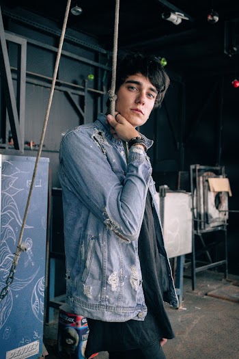Man Wearing Denim Jacket Holding Rope