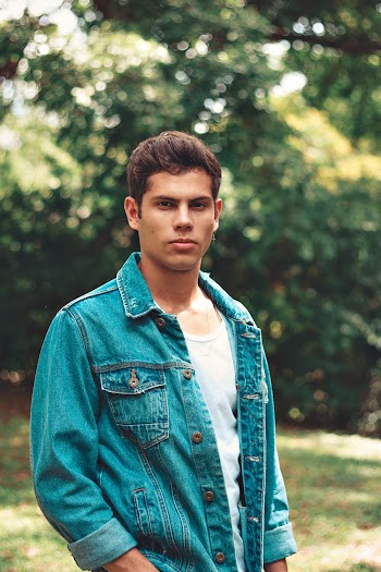 Man Wearing Denim Jacket Standing Under Tree