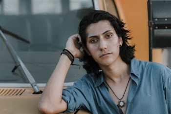 Man Wearing Dress Shirt Leaning on School Bus