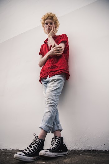 Man Wearing Dress Shirt Standing Near Concrete Wall