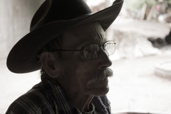 Man Wearing Eyeglasses and Cowboy Hat