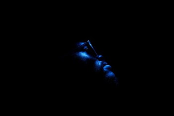 man wearing eyeglasses in dark room