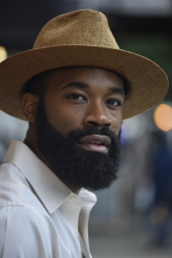 Man Wearing Fedora Hat and White Polo Shirt