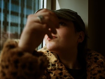man wearing fur coat and cap