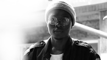 Man Wearing Glasses, Beanie Hat, and Jacket Looking Straight