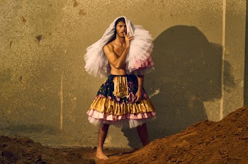 Man Wearing Gold and Pink Skirt