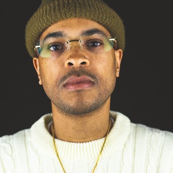 Man Wearing Gold-colored Necklace and Brown Knit Cap