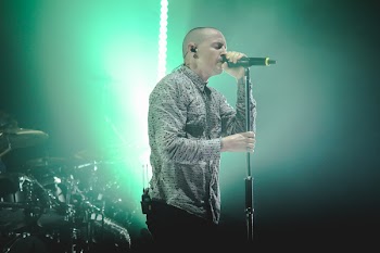 Man Wearing Gray Button-up Dress Shirt Holding Black Cordless Microphone With Stand