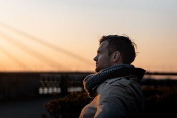 Man Wearing Gray Coat during Golden Hour